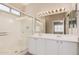 Well-lit bathroom with a glass-enclosed shower and a double vanity with white cabinets at 10352 E Second Water Trl, Gold Canyon, AZ 85118