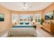 Inviting bedroom with bay windows, soft natural light, and a cozy white and teal color scheme at 10352 E Second Water Trl, Gold Canyon, AZ 85118