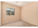 Bedroom with cozy carpeting, ceiling fan, and a window offering natural light at 10352 E Second Water Trl, Gold Canyon, AZ 85118