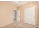 Neutral bedroom featuring carpet floors, ceiling fan, closet, and a door leading to the rest of the home at 10352 E Second Water Trl, Gold Canyon, AZ 85118