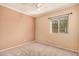 Comfortable bedroom with neutral carpeting, ceiling fan, and a window offering natural light at 10352 E Second Water Trl, Gold Canyon, AZ 85118