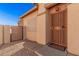 Close-up of front door with security screen and tiled walkway leading to a gated side yard at 10352 E Second Water Trl, Gold Canyon, AZ 85118