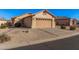 A single-story home featuring desert landscaping and a two-car garage, with a clear blue sky above at 10352 E Second Water Trl, Gold Canyon, AZ 85118