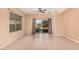 Bright living room with neutral paint, tile flooring, a ceiling fan, and sliding glass doors to the backyard at 10352 E Second Water Trl, Gold Canyon, AZ 85118