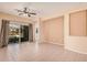 Open-concept living space with tile flooring, neutral walls, and a glass sliding door leading to the backyard at 10352 E Second Water Trl, Gold Canyon, AZ 85118