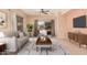 Bright living room featuring neutral tones, comfortable seating, and a stylish ceiling fan at 10352 E Second Water Trl, Gold Canyon, AZ 85118