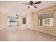 Open-concept living area with neutral colors, tile flooring, and a view of the kitchen in the background at 10352 E Second Water Trl, Gold Canyon, AZ 85118