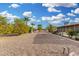 Backyard featuring desert landscaping with mature citrus trees offering natural beauty and shade at 10414 W Ponderosa Cir, Sun City, AZ 85373