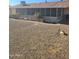 Cozy backyard featuring a screened-in porch and low-maintenance gravel landscaping at 10414 W Ponderosa Cir, Sun City, AZ 85373