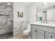 Modern bathroom featuring marble tiled shower, sleek vanity, and updated fixtures at 10414 W Ponderosa Cir, Sun City, AZ 85373