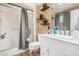 Updated bathroom featuring white cabinets, marble countertop and a tiled shower at 10414 W Ponderosa Cir, Sun City, AZ 85373