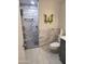 Modern bathroom featuring a marble-tiled shower, grey vanity, and stylish decor, creating a serene space at 10414 W Ponderosa Cir, Sun City, AZ 85373