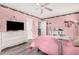 Bedroom with pink walls, a ceiling fan, and white furniture at 10414 W Ponderosa Cir, Sun City, AZ 85373