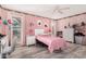 Cozy bedroom with pink walls, a ceiling fan, and plenty of natural light at 10414 W Ponderosa Cir, Sun City, AZ 85373