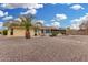 Desert landscaped yard of a single story home featuring a covered patio and desert trees at 10414 W Ponderosa Cir, Sun City, AZ 85373