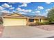 Inviting single-story home featuring a yellow facade, 2-car garage, and solar panels at 10414 W Ponderosa Cir, Sun City, AZ 85373