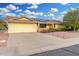 Inviting single-story home featuring a yellow facade, 2-car garage, and solar panels at 10414 W Ponderosa Cir, Sun City, AZ 85373