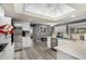 Open kitchen area featuring stainless steel appliances, white cabinets, and a skylight at 10414 W Ponderosa Cir, Sun City, AZ 85373