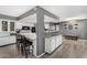 Open concept kitchen featuring an island with seating, stainless appliances and white cabinets at 10414 W Ponderosa Cir, Sun City, AZ 85373