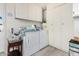 Bright laundry room featuring modern washer, dryer, storage cabinets and flooring at 10414 W Ponderosa Cir, Sun City, AZ 85373