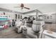 Open concept living room featuring comfortable seating, an adjacent kitchen, and lots of light at 10414 W Ponderosa Cir, Sun City, AZ 85373