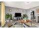 Well-lit living room featuring gray walls, decorative mirrors, and modern furnishings at 10414 W Ponderosa Cir, Sun City, AZ 85373