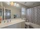 Bathroom with a large mirror, white vanity and a geometric shower curtain at 10423 W Hughes Dr, Tolleson, AZ 85353