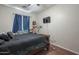 Cozy bedroom with dark wood flooring and a contrasting black bed set at 10423 W Hughes Dr, Tolleson, AZ 85353