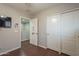 Bedroom with wood floors, closet and view to the hallway at 10423 W Hughes Dr, Tolleson, AZ 85353