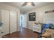 Spacious bedroom featuring wood floors, ceiling fan and closet at 10423 W Hughes Dr, Tolleson, AZ 85353