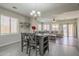 This dining room features sleek tile floors, a modern chandelier, and a cozy living space at 10423 W Hughes Dr, Tolleson, AZ 85353