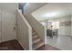 A welcoming entryway with staircase view of dining room offers a peek at the dining area at 10423 W Hughes Dr, Tolleson, AZ 85353