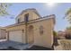 Two-story stucco home with attached garage, archway and desert landscaping at 10423 W Hughes Dr, Tolleson, AZ 85353