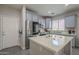 Well-lit kitchen with stainless steel appliances, white countertops and gray cabinets at 10423 W Hughes Dr, Tolleson, AZ 85353