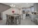 Eat-in kitchen featuring grey cabinets, tile floors, stainless appliances, and modern lighting at 10423 W Hughes Dr, Tolleson, AZ 85353