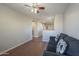 Comfortable living room area features a cozy seating arrangement and ceiling fan at 10423 W Hughes Dr, Tolleson, AZ 85353