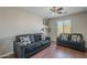 This cozy living room features a comfortable seating arrangement and decorative accents at 10423 W Hughes Dr, Tolleson, AZ 85353