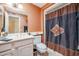 Bathroom featuring an earth tone paint, shower with a decorative curtain, and a large mirror at 10461 W Loma Blanca Dr, Sun City, AZ 85351