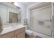 Well-lit bathroom with a vanity, toilet, and shower at 10461 W Loma Blanca Dr, Sun City, AZ 85351