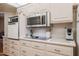 Kitchen with a combination oven-microwave, flat top range and light countertops at 10461 W Loma Blanca Dr, Sun City, AZ 85351