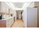 Well-lit kitchen featuring light-colored cabinets and countertops, stainless steel appliances, and hardwood floors at 10461 W Loma Blanca Dr, Sun City, AZ 85351