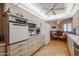 Bright kitchen featuring wooden floors, and updated appliances at 10461 W Loma Blanca Dr, Sun City, AZ 85351