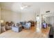 Bright living room with hardwood floors and combined dining and entry way space at 10461 W Loma Blanca Dr, Sun City, AZ 85351