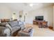 Bright living room featuring hardwood floors and a combined dining room space at 10461 W Loma Blanca Dr, Sun City, AZ 85351