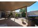 Relaxing covered patio with outdoor dining area and barbecue perfect for outdoor entertaining at 10461 W Loma Blanca Dr, Sun City, AZ 85351