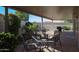 Charming covered patio with dining and barbecue area provides a tranquil outdoor living space at 10461 W Loma Blanca Dr, Sun City, AZ 85351