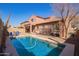 Spacious backyard with a pool, patio, and lush greenery, creating a private oasis at 10684 N 161St Ave, Surprise, AZ 85379