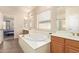 Well lit bathroom featuring a soaking tub and dual sinks at 10684 N 161St Ave, Surprise, AZ 85379