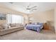 A sprawling bedroom features a couch and neutral carpeting at 10684 N 161St Ave, Surprise, AZ 85379