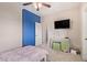 Bedroom featuring a colorful blue accent wall and a TV at 10684 N 161St Ave, Surprise, AZ 85379